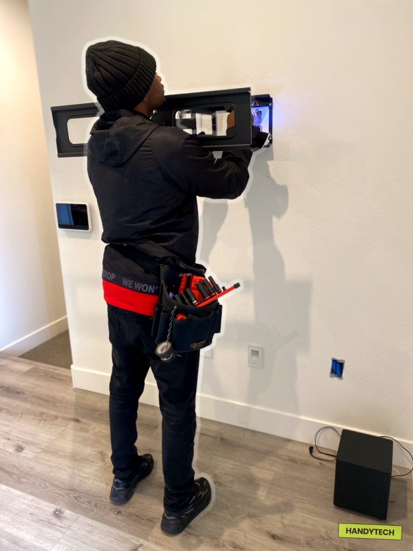 Kevin Cass Womack leveling a TV mount bracket in Hattiesburg MS